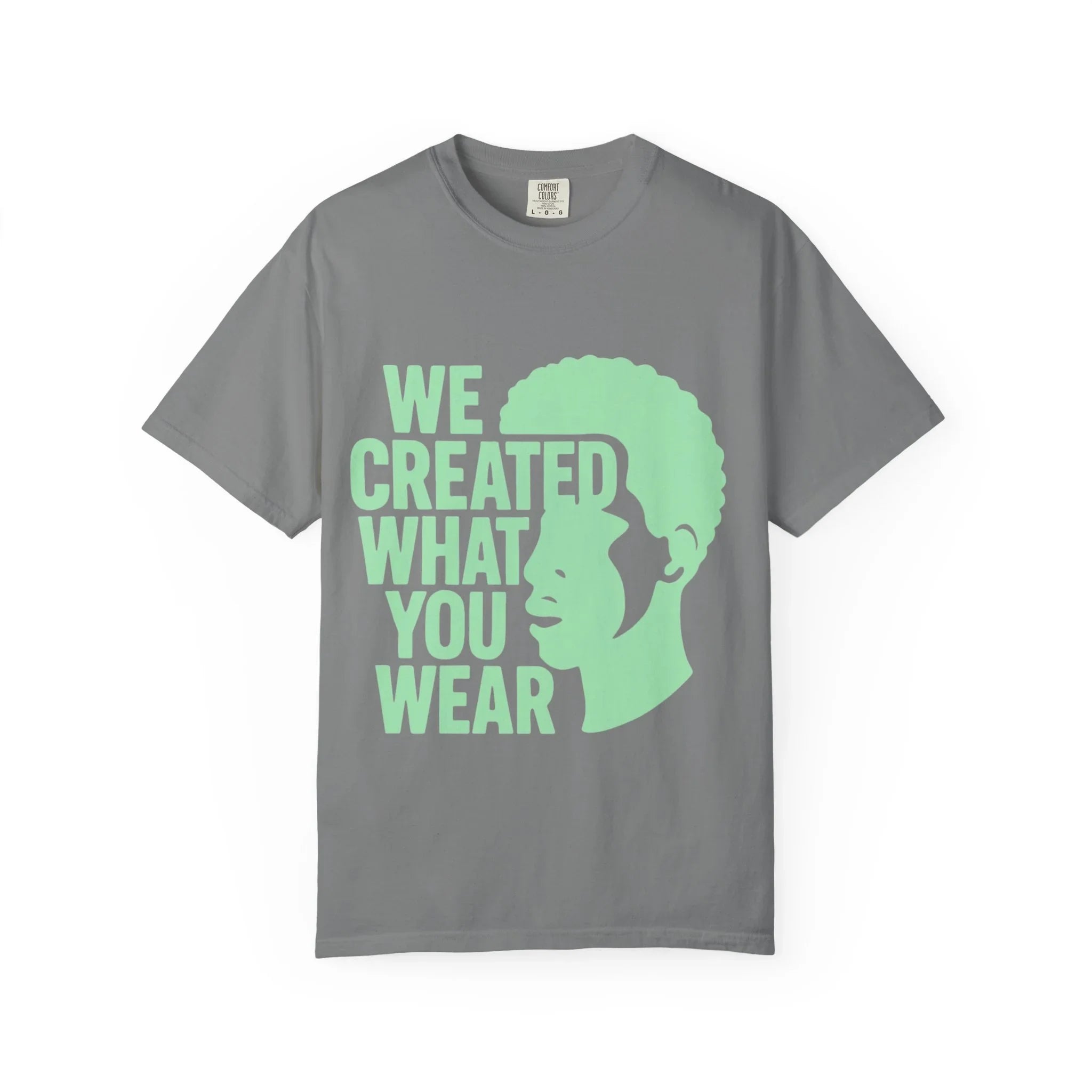 Gray t-shirt with green 'We Created What You Wear' text and silhouette design
