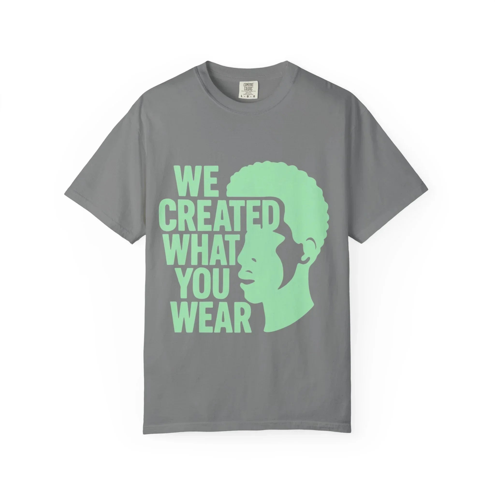Gray t-shirt with green 'We Created What You Wear' text and silhouette design