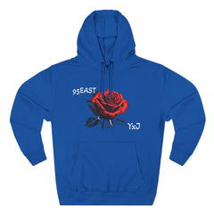 Royal blue hoodie with red rose graphic and 95EAST YxJ text, featuring front pouch pocket and drawstring hood