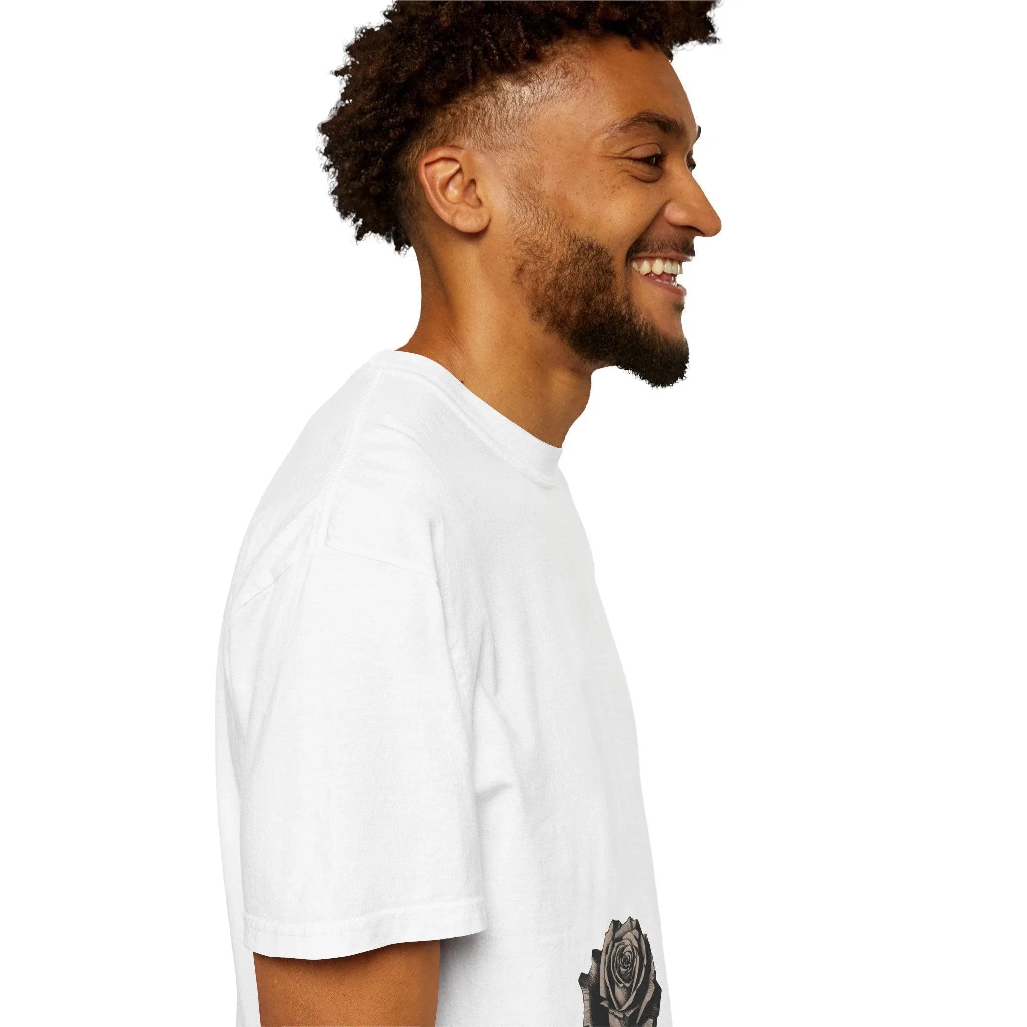 Man wearing white t-shirt with rose graphic, smiling in side profile