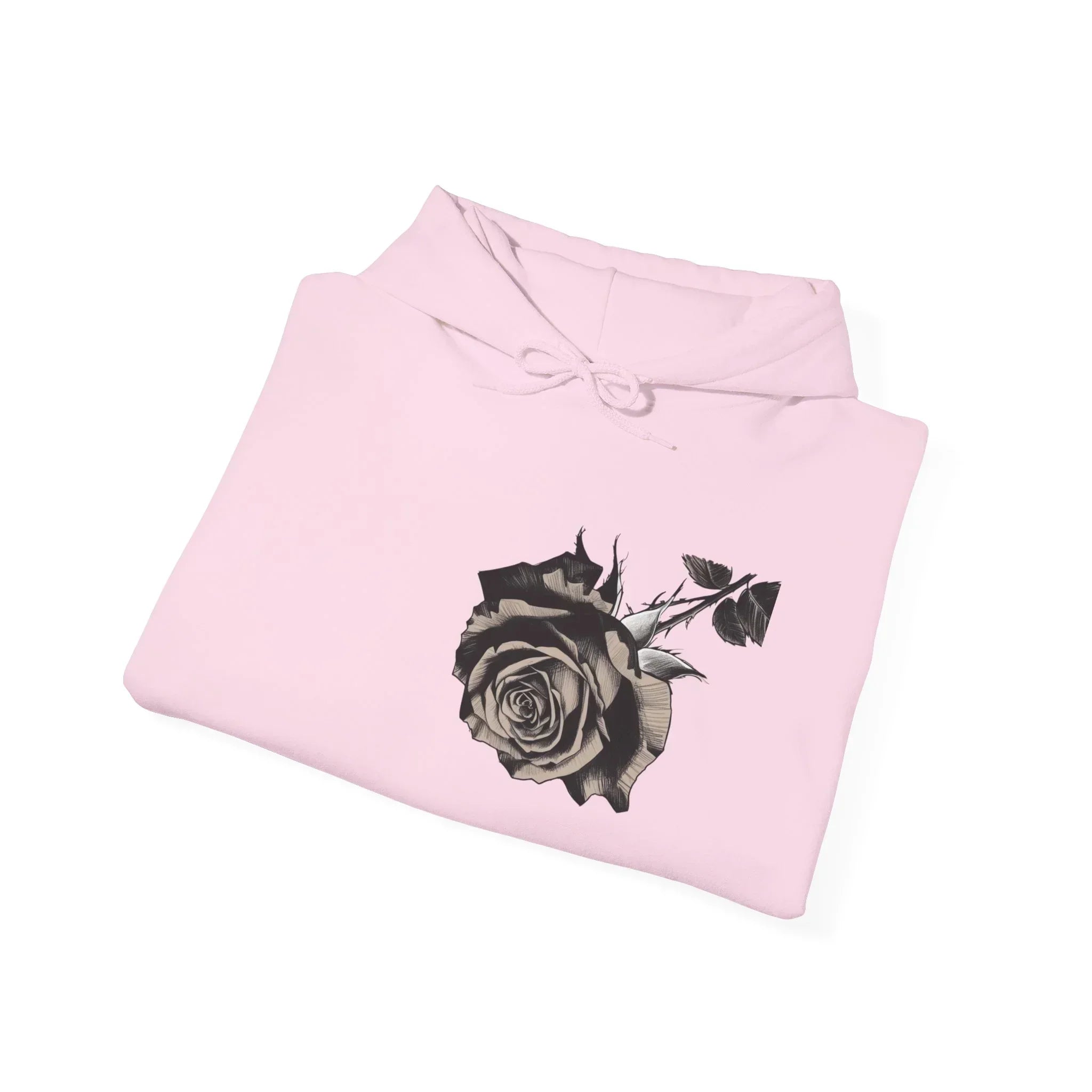 Folded light pink hoodie with black rose and leaf graphic on front