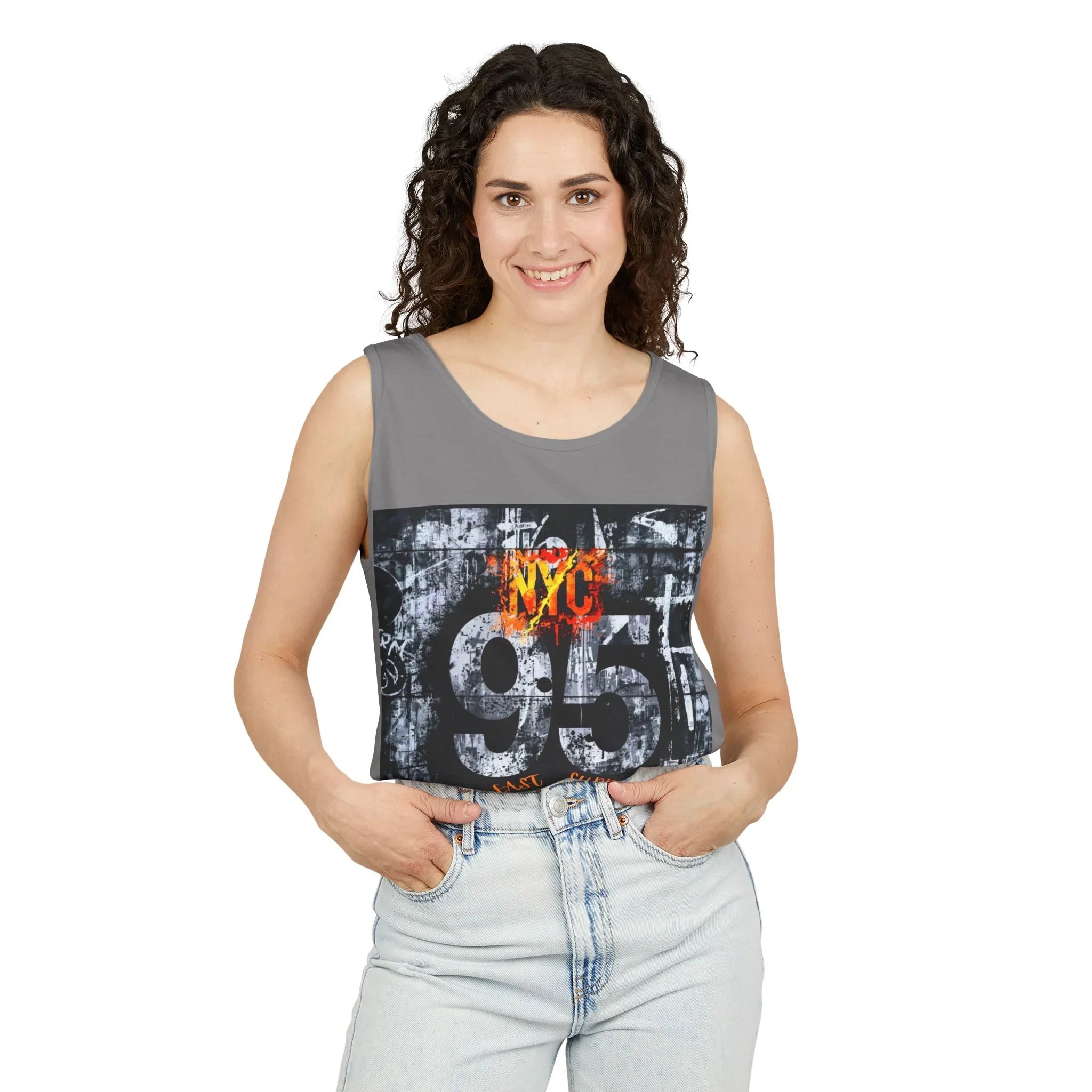Woman wearing gray NYC 95 graphic tank top with urban street art design, paired with light denim jeans.