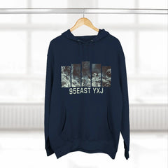 Navy blue hoodie with abstract graphic bars and 95EAST YXJ text, hanging on wooden hanger