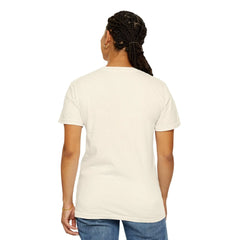 Woman wearing cream cotton t-shirt with braided hair, gold hoop earring, and blue jeans