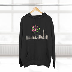 Black hoodie with pink and green rose graphic over city skyline, barcode detail on sleeve