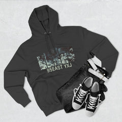 Black hoodie with abstract graphic and 95EAST YXJ text, paired with black jeans, white belt, and sneakers