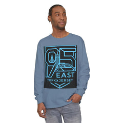 Man wearing blue long sleeve shirt with 95 East YorkxJersey graphic, featuring city skyline and bridge design.
