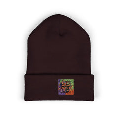 Dark brown beanie with colorful embroidered patch logo on front cuff, isolated on white