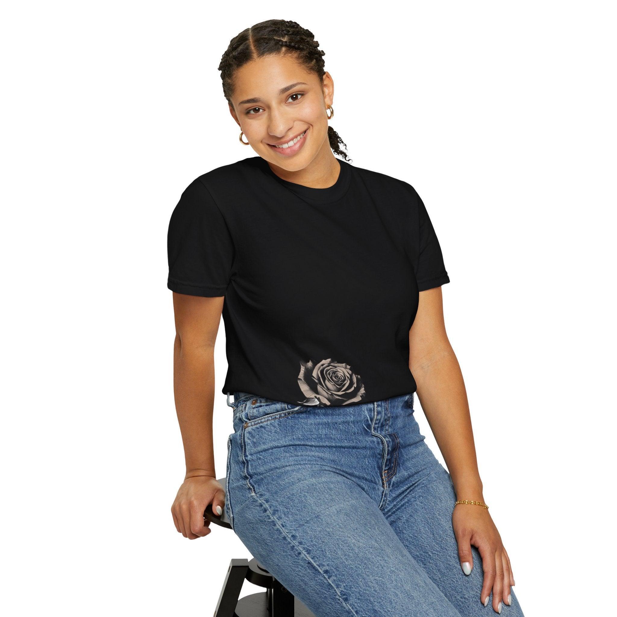 Black t-shirt with rose graphic, paired with blue jeans, styled for modern East Coast fashion.