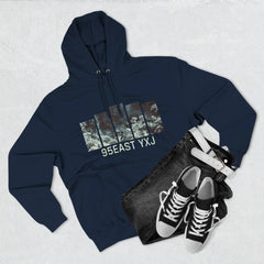 Navy blue hoodie with graphic print and 95EAST YXJ text, paired with black jeans, belt, and sneakers