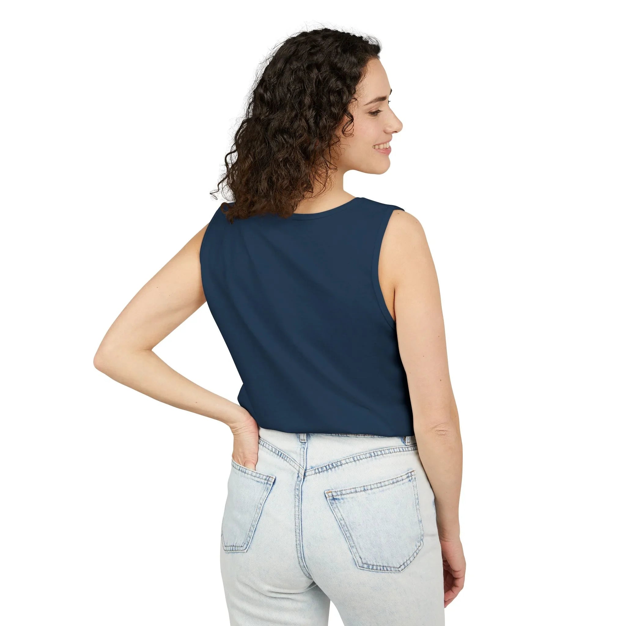 Woman in navy blue sleeveless top and light denim jeans, facing away, on white background