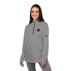 Woman wearing gray quarter-zip pullover with red rose graphic and athletic logo, casual outfit