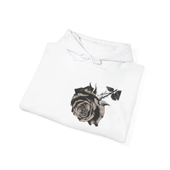 White hoodie with black rose graphic print, folded on a white background