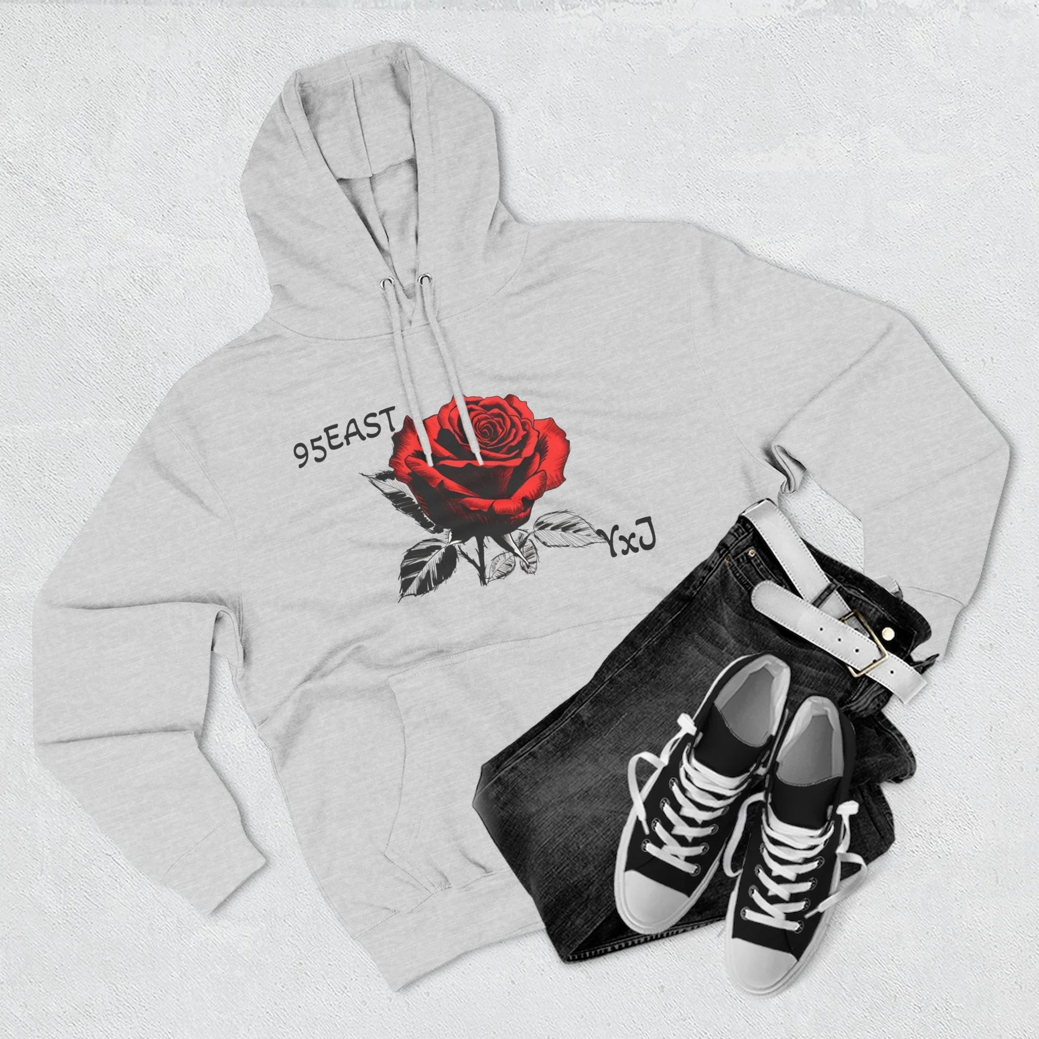 Gray hoodie with red rose graphic and 95EAST YxJ text, styled with jeans and sneakers