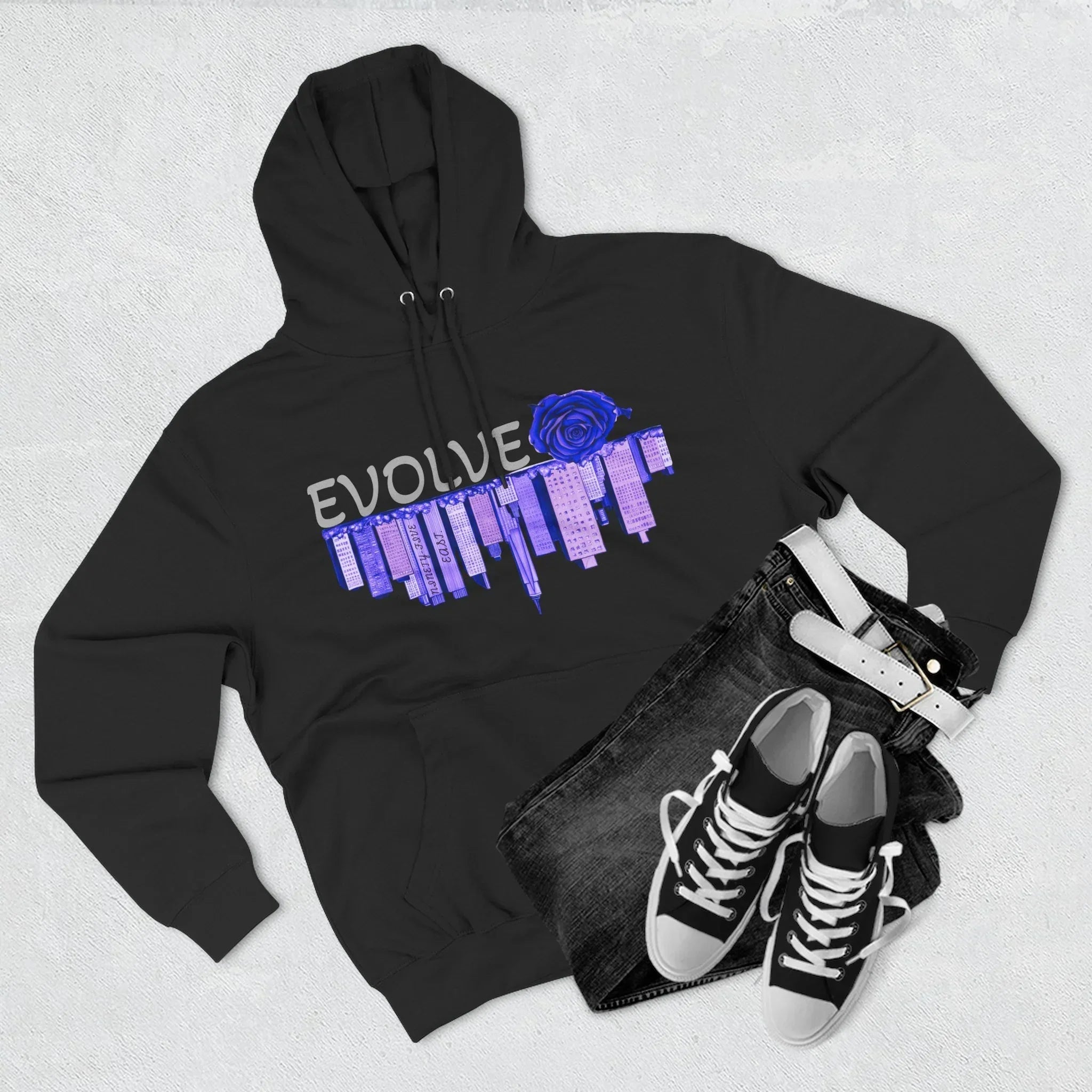 Black hoodie with blue rose and city graphic, paired with jeans and sneakers