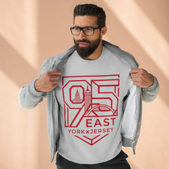 Man wearing gray hoodie with red 95 East YorkxJersey graphic, showcasing urban design and modern streetwear style