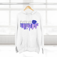 White hoodie with 'EVOLVE' text, blue rose, and city skyline graphic, hanging on wood hanger