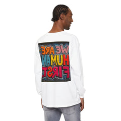 Man wearing a white long sleeve shirt with colorful graffiti text on the back, casual style