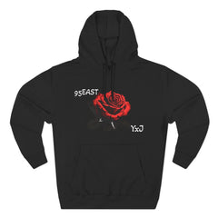 Black hoodie with red rose graphic and '95EAST YxJ' text, featuring barcode sleeve detail for streetwear style.