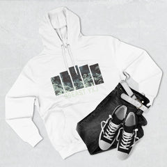 White hoodie with nature graphic and '95EAST YXJ' text, black jeans, sneakers, white belt