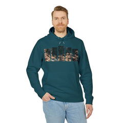 Man wearing teal hoodie with coral reef print, paired with light jeans, showcasing casual coastal style.