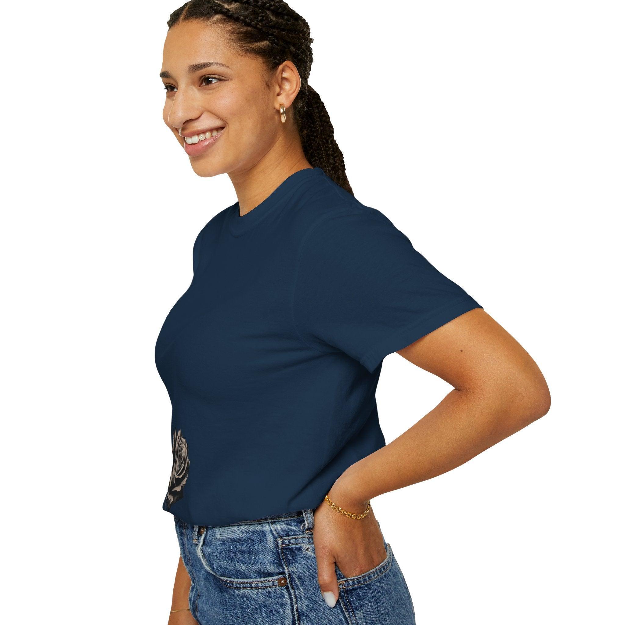 Woman wearing navy blue t-shirt with rose graphic, paired with denim jeans, showcasing casual style.