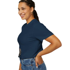 Woman wearing navy blue t-shirt with rose graphic, paired with denim jeans, showcasing casual style.