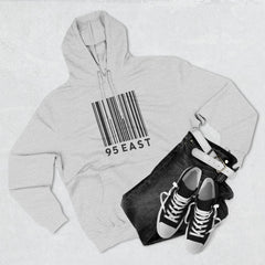 Gray hoodie with barcode design and '95 EAST' text, paired with black jeans and sneakers.