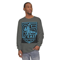 Man wearing gray long sleeve tee with 95 East York x Jersey graphic, featuring city skyline and bridge design