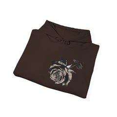 Folded black hoodie with a large monochrome rose graphic on the front, minimalist design