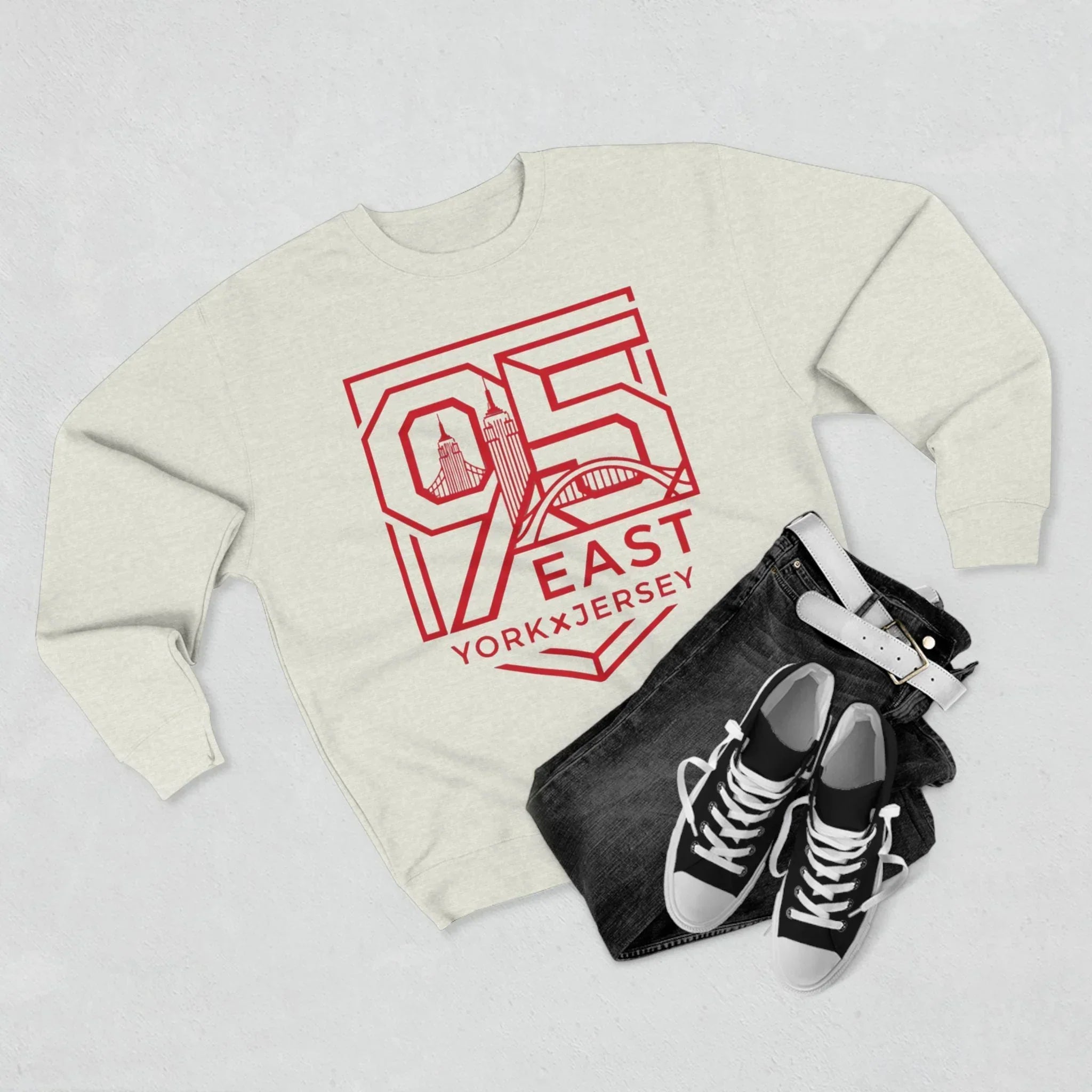Cream hoodie with red 95 East YorkxJersey graphic, paired with black jeans and sneakers