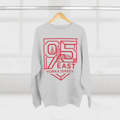 Gray hoodie with red 95 East YorkxJersey graphic, city skyline design, hanging on wood hanger