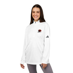Smiling woman wearing a white quarter-zip pullover with red rose embroidery and black logo sleeve detail