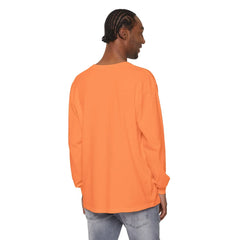 Man wearing vibrant orange long sleeve tee, styled with light denim jeans, showcasing casual streetwear look.