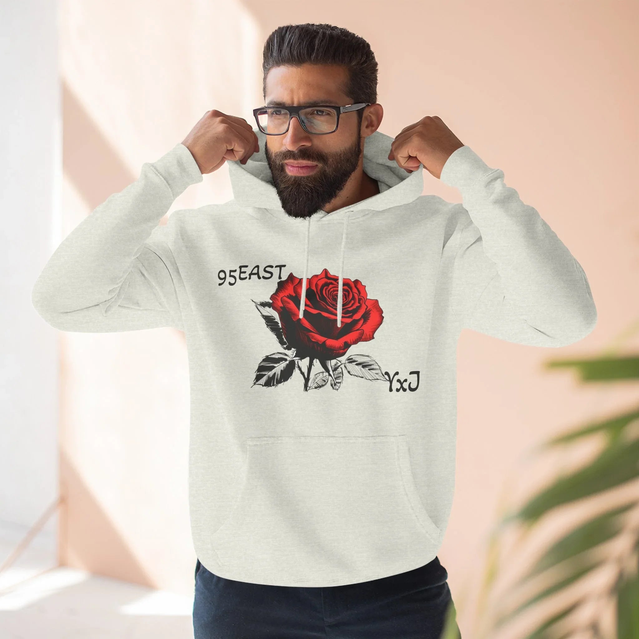 Black hoodie with red rose graphic and barcode sleeve detail, East Coast style