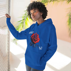 Blue hoodie with red rose graphic and YxJ text, worn by woman near chain-link fence