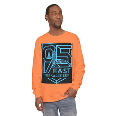 Man wearing orange long sleeve tee with bold 95 East YorkxJersey graphic print, urban skyline design