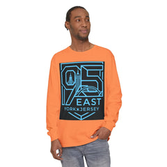 Man wearing orange long sleeve tee with bold 95 East YorkxJersey graphic print, urban skyline design
