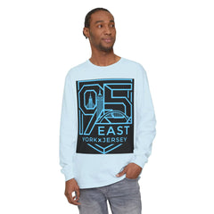 Man wearing light blue long sleeve tee with 95 East YorkxJersey graphic, featuring city skyline and bridge design