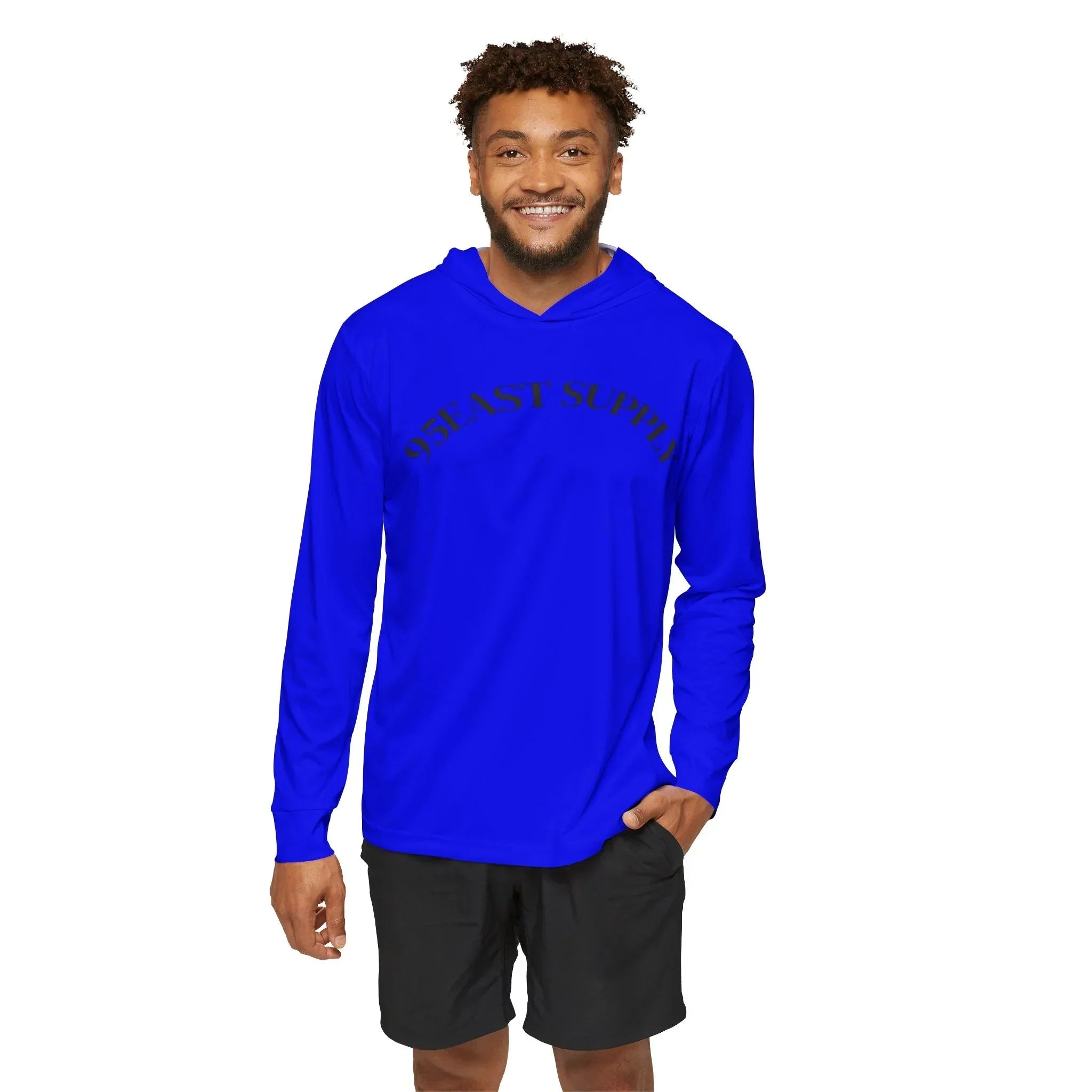 Man wearing royal blue 95EAST SUPPLY hoodie, smiling, casual streetwear style