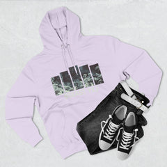 Light lavender hoodie with graphic print, black jeans with white belt, and black sneakers flat lay