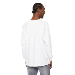 Man wearing white long-sleeve shirt and gray jeans, showcasing casual East Coast style