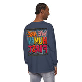 Man wearing blue long sleeve shirt with colorful graffiti art reading 'We Are Human First' on back