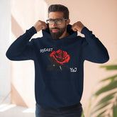 Black hoodie with red rose graphic and barcode sleeve detail, worn by man adjusting hood