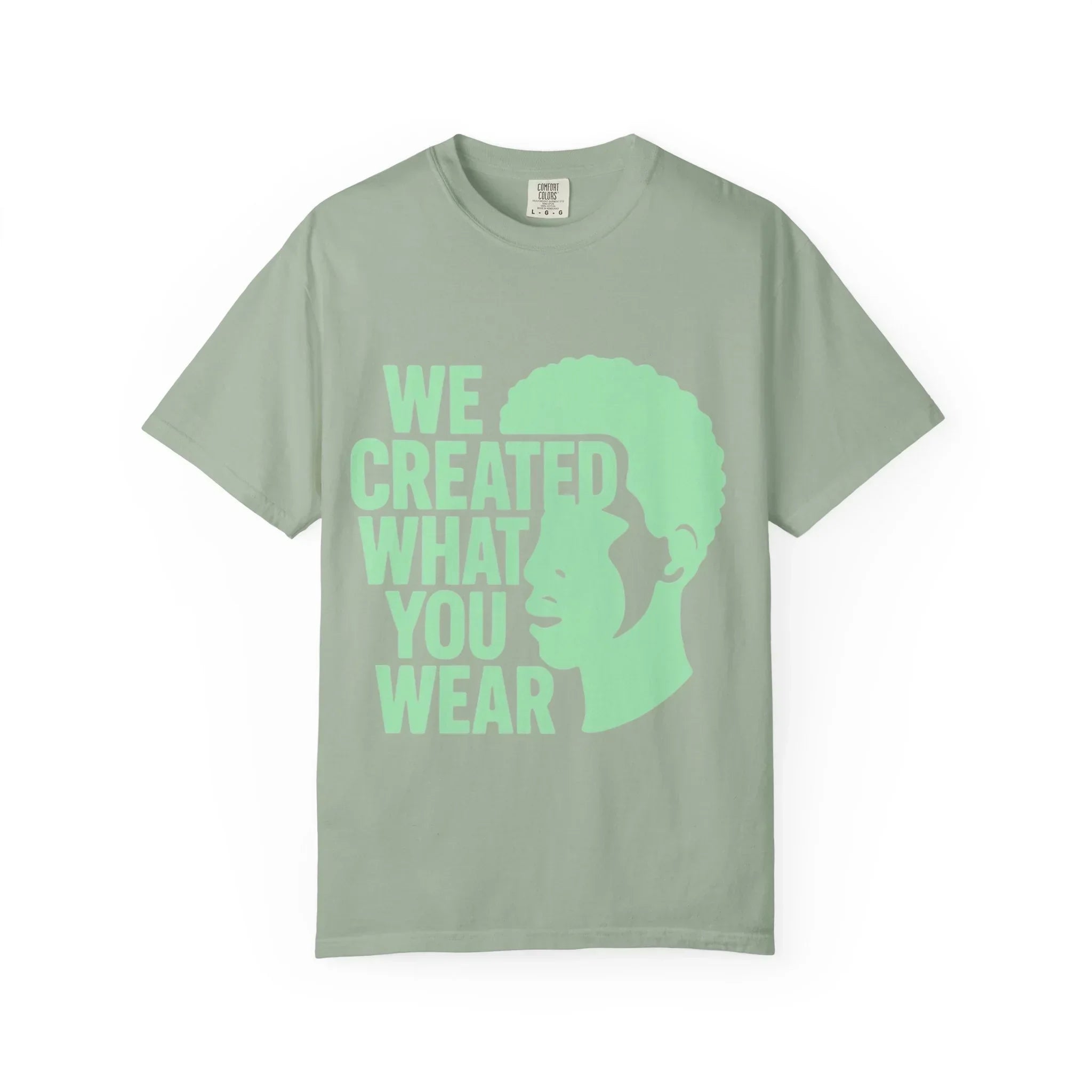 Green t-shirt with 'WE CREATED WHAT YOU WEAR' text and silhouette design