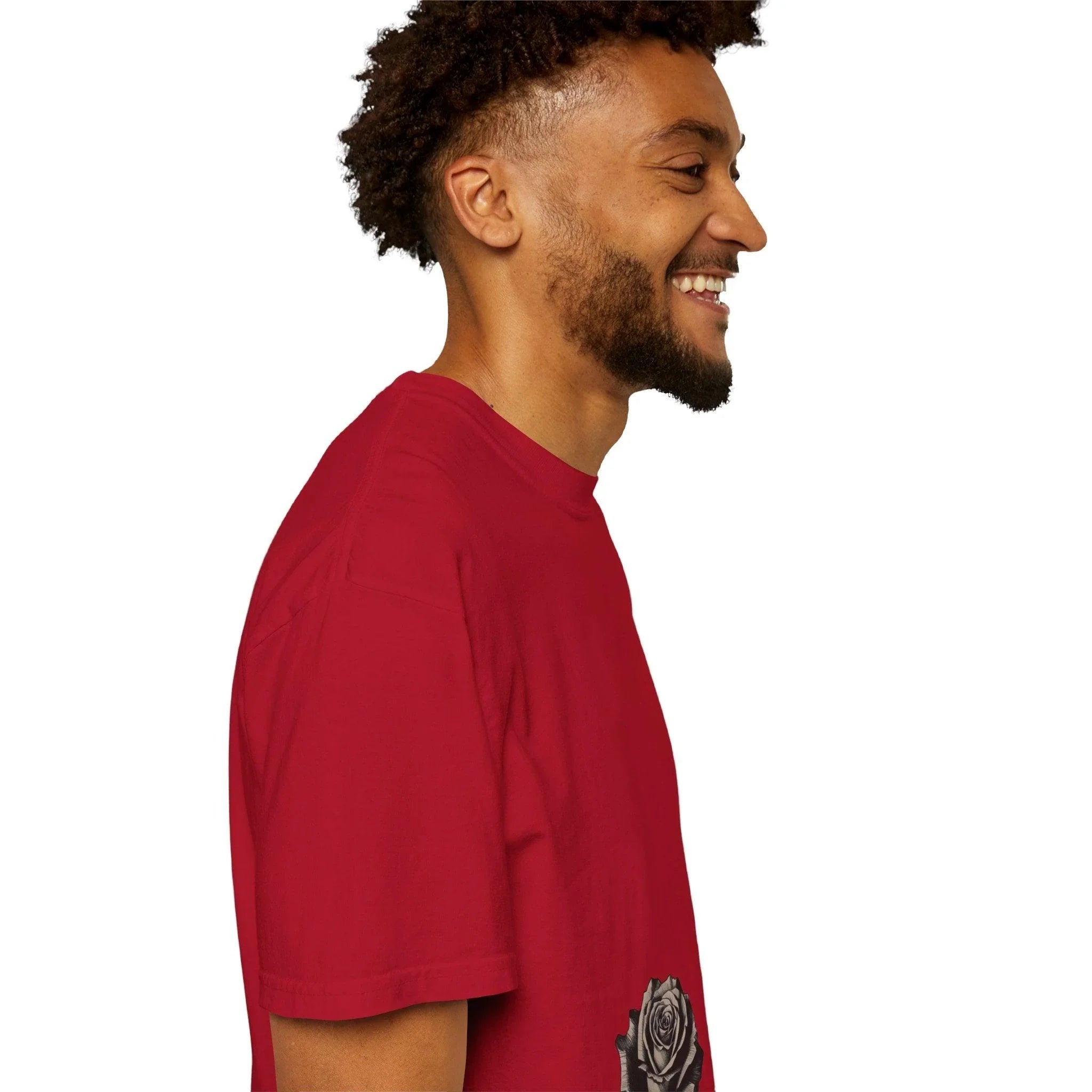 Man in red graphic tee with rose print, smiling in side profile