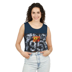 Woman wearing navy tank top with NYC 95 graphic print, styled with light wash jeans for urban streetwear look
