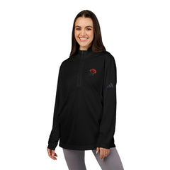 Woman wearing a black quarter-zip pullover with a red rose embroidered on the chest.