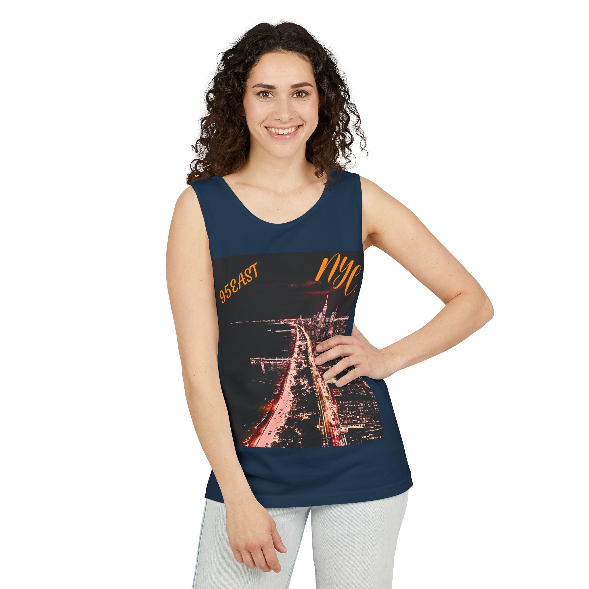 Woman wearing navy NYC tank top with city nightscape graphic and casual jeans