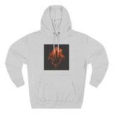 Light gray hoodie with orange cityscape and hand graphic on black square chest patch
